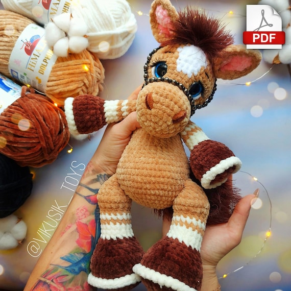 10.97 USDIn this pattern you can learn how to crochet a horse with gorgeous mane made of textured yarn or make a multi-colored curls. And if you crochet a horn you'll get a beautiful unicorn.Please note: this is not a readymade toy. Materials not included. The finished toy is ~12.5 inches / 32 cm tall using a 3.75 mm crochet hook and stated materials.I used:3.75-4 mm crochet hook.Worsted weight yarn: Himalaya Dolphin Baby 100 g of the basic color.Additional color for the hooves, ears, and spots.Yarn: Lanoso Single (similar yarn: Yarnart TANGO, or YarnArt Sambа, or Аlize decofur) for the mane and tail.Safety eyes D=18 mm.Black DK weight yarn for eyelids and eyebrows embroidery (such as kids novelty, YarnArt Jenas or similaryarn).Firm thread for sewing (I use sewing thread).Sculpting thread (I use YarnArt Jeans).Lighter.Tapestry needle (long and short).Pins.Scissors.Stitch markers.Glue and artificial eyelashes.This pattern tutorial includes one PDF file with 20 pages of detailed descriptions of how to crochet your toy with simple step-by-step instructions (language: English and Russian) and plenty of photos.Abbreviations (US):MR – magic ringsc – single crochetinc – increase – two single crochet in one stitchdec – decrease – two single crochet togetherch – chainsl st – slip stitch(…) inc – repeat increases are instructed(….) х 6 times – repeat 6 times or as instructedThis is a paid pattern!This pattern is protected by copyright, and it is Intended only for personal use. This pattern is a work of authorship of Victoria Kravchenko. It is forbidden: change the pattern in whole or partly, use the instructions for your patterns or video tutorials, full or partial reproduction and distribution, exchange or send this pattern to third parties. It is forbidden to publish this pattern in a whole or partly on the internet, on public social networks, or private pages.Feel free to contact me if you have any questions.