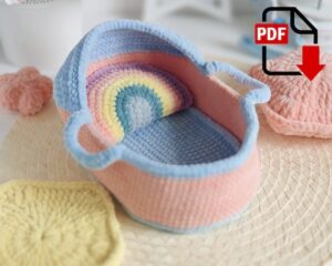 7.39 USDBaby doll mini basket. Crochet pattern PDF. A baby cradle pattern.(including a pillow, a blanket, a mattress). Doll pattern do not included.Baby dolls. Crochet patternhttps://www.etsy.com/listing/1308571562PATTERN AVAILABLE IN ENGLISH AND RUSSIAN ONLY.PLEASE NOTE: THIS PURCHASE IS ONLY FOR A DIGITAL CROCHET PATTERN, NOT THE FINISHED TOY. MATERIALS NOT INCLUDED.Instant digital download - ready to download once payment is confirmed.You will see the download link in details of your order.Final size of the toy with the recommended materials and tools 8.7*5.1*3.1 in (22*13*8 cm).You can use your favorite materials and tools, but final size of the toy may differ.Please note that each master has his own style and density of crochet. The size of the finished toy may vary from the size indicated in the template.List of recommended materials and tools:•Yarn HiMALAYA Dolphin Baby, gauge: 120m/100gr.•For the baby cradle I choose pink yarn color code 346, light blue yarn color code 347 – 1yarn ball for each color.•Some yellow yarn color for the blanket star – color code 313 and some different yarncolors for the rainbow pillow.•Size 2.75 or 3mm crochet hook.Final size of the cradle 22x13cm, 8cm height.•Scissors.•Stitch markers.Abbreviations (US crochet terms):ch1 – a chain stitch.ch2, ch3 – 2 or 3 chain stitches. sc – single crochet.hdc – half double crochet. dc – double crochet. increase – work 2 sc into one stitch. increase dc – work 2 dc into one stitch. decrease – close 2 stitches together grabbing front loops only. decrease dc - close 2 stitches together grabbing front loops only. sl st – slip stitch.
