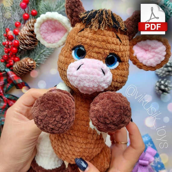 10.97 USDCrochet bull pattern, toy pattern for kids, crochet tutorial in PDF format.Language: English and Russian.Please note: this is not a readymade toy. Materials not included. Materials used:Yarn usage and height of this toy depends on your crocheting density, yarn batch, yarn brand and number of your crochet hook I used safety eyes 16mm in color dark blueYarn i used:Cow number one:Main color (100-150g.) YarnArt Dolce - №754 (gray brown).Horns, hooves (35-40g.) - Himalaya Dolphin Baby - №337(brown).Mouth, inner part of the ear (5g.) - Himalaya Dolphin Baby - №333(light peach).Cow number two - body with splashes of color and different legs.Body (100g.) - Himalaya Dolphin Baby №337 (brown).Accent body color (30-40g.) - Himalaya Dolphin Baby №333(ligh peach).Mouth, inner part of the ear (5g.) - Himalaya Dolphin Baby №303(powder pink).Horns, hooves (35-40g.) - YarnArt Dolce - №754(gray brown).Alternative colors:I suggest brown hooves, №339 or №322.For mouth and inner part of the ear:Himalaya Dolphin Baby - YarnArt DolceColor №303 (powder-pink). or №750(light pink).For horns and hooves:Himalaya Dolphin Baby №343(brown)Body ideas:YarnArt DolceColor №757(mustard)Color №765(brown)Color №747(beige)Himalaya Dolphin BabyColor №330(mustard)Color №337(brown)Color №317(beige)Colors are displayed as an example, I suggest you to look to yarn shops where you can find for example milky tones and other interesting colors. You also need little bit of white plush yarn for sewing the white parts of the eye. Little bit of thin black and brown yarn for hair, eyebrows and tail. Yarn for sewing parts together. Abbreviations (US):MR – magic ringsc – single crochetinc – increase – two single crochet in one stitchdec – decrease – two single crochet togetherch – chainsl st – slip stitch(…) inc – repeat increases are instructed(….) х 6 times – repeat 6 times or as instructed This is a paid pattern!This pattern is protected by copyright, and it is Intended only for personal use. This pattern is a work of authorship of victoria kravchenko. It is forbidden: change the pattern in whole or partly, use the instructions for your patterns or video tutorials, full or partial reproduction and distribution, exchange or send this pattern to third parties. It is forbidden to publish this pattern in a whole or partly on the internet, on public social networks, or private pages. Feel free to contact me if you have any questions.