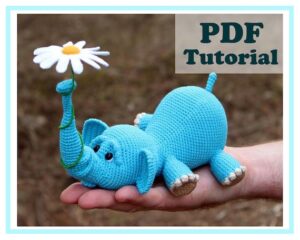 5.60 USDAmigurumi Elephant and balloon. Amigurumi Elephant and flower. Crochet pattern PDF. Tutorial.!!! Language: ONLY ENGLISH !!!Pattern Crochet PDF Tutorial - Instant downloadPDF pattern includes instructions on 17 pages, 28 photos, 16 videos. (The elephant pattern, pattern of the flower and balloon) Dimensions of my elephant: length 22 cm, height 9 cm, trunk height 14 cm.Legs, head and trunk of an elephant do not sew, they are crocheted at once.Pattern is written in English.Level: advanced beginner/intermediate.This listing is for a PDF PATTERN INSTANT DOWNLOAD, not a finished product.Materials:- YarnArt Baby, 150m/50g, 100% acrylic, 1.5 skeins of yarn. (or any other yarn made up of acrylic, acrylic/cotton)- Thin yarn for flower - white, yellow, green (I have Alize Miss)Dimensions of my elephant: length 22 cm, height 9 cm, trunk height 14 cm.If you need a smaller size, then take the yarn thinner. If you need a large size, then take the yarn thicker. - Hook 2 mm (if no other hook is specified on the label)- Eyes 10 mm- Wire (40 cm for trunk and 12 cm for flower stem)- Hollow fiber (or other stuffing material).- Cardboard.- Glue (to glue eyes).- Needle, scissors (to sew the tail)
