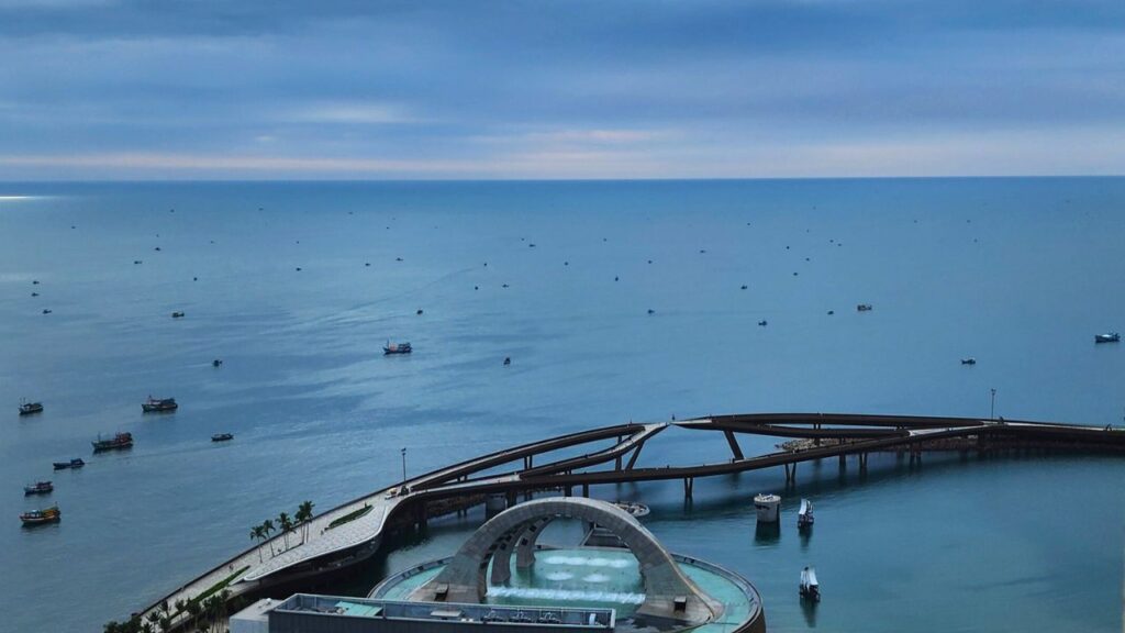 Night view of Kiss of the Sea in Sunset Town, Phu Quoc, with water projections, stage effects, and fireworks above the sea.
