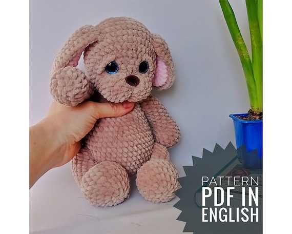 8.00 USDCrochet pattern for a soft plush puppy with floppy ears and a cuddly chenille texture. This PDF tutorial will help you create an adorable dog toy that works beautifully as nursery decor, a baby shower gift, or a handmade birthday present for dog lovers. The design is inspired by classic stuffed animals and is perfect for anyone who enjoys making cozy amigurumi toys from velvet yarn.All photos show real handmade toys created from this pattern. This pattern is written by a human, not generated by AI.Please note: this is not a readymade toy. Materials not included.Language: English.Materials: Trapezoid plastic (safety) eyes 2 pcs. – 16-18 mm Nose – 20 mm Super Bulky/Super Chunky/14ply yarn: Himalaya dolphin baby a little of pinkcolor No.80303,1-2 skeins of brown color No.80337 or any other color. Strong thread (I have Iris) in the color of the main yarn (for sewing pieces). Cotter pins – 2 pcs. Disks for pins 4 pcs. – 25-30 mm  Crochet hook – 4 mm Needle for sewing pieces. Fiberfill Super GlueThe size of the finished toy from the recommended materials is 11.8 in (30cm).