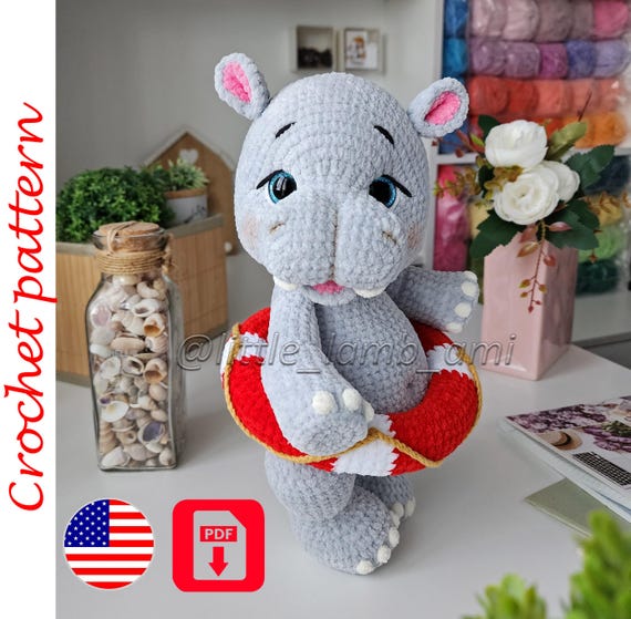 12.20 USDCrochet pattern for a plush hippo with a colorful lifebuoy. This PDF tutorial will help you make a soft amigurumi toy with sweet embroidered details, chunky proportions, and a playful summer look. The pattern is suitable for intermediate crocheters and makes a wonderful nursery decoration, baby shower gift, or handmade toy for any hippo lover.Please read before purchasing:* Digital PDF download only - no physical item will be shipped.* Pattern language: English.* This pattern is written by a human designer and is not AI-generated.* All photos in this listing show real toys crocheted from this pattern.What's included:* PDF crochet pattern.* Step-by-step written instructions in English.* Detailed assembly and finishing guidance for the hippo and lifebuoy.Finished size:Using the recommended Himalaya Dolphin Baby yarn, the finished hippo measures approximately 13.4 in (34 cm) tall.Using Himalaya Dolphin Fine yarn, the finished hippo measures approximately 11 in (28 cm) tall.The final size may vary depending on your yarn choice, hook size, and individual crochet tension.Materials and tools:- For the larger version:* Himalaya Dolphin Baby yarn (120 m / 100 g) – approximately 2 skeins of the main color, plus small amounts of white, pink, and a contrasting color for details.* Yarn for facial embroidery.* 3.5 mm crochet hook.* 20 mm safety eyes.* Fiberfill stuffing.* Tapestry needle.* Stitch marker.* Scissors.* Cotter pins and discs for movable head and legs.* Cardboard for structural support.* Dry pastel and a small brush for shading.* Glue gun.- For the smaller version:* Himalaya Dolphin Fine yarn.* 3 mm crochet hook.* 18 mm safety eyes.* Fiberfill stuffing.* Cotter pins and discs for movable head and legs.This crochet pattern creates a standing plush hippo with a removable lifebuoy, making it a fun summer-themed project for your handmade toy collection. The finished toy looks beautiful in soft pastel colors, but you can easily customize it with your favorite yarn shades.