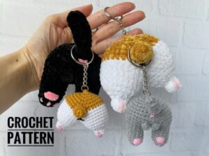4.99 USDKeychain Cat butt and Dog butt, made with your own hands, will be a great and fun gift. This crochet pattern will help you to make a keychain. This keychain would be a great gift for cat and dog lovers.This is NOT THE FINISHED KEYCHAIN! This is DOWNLOADABLE PDF CROCHET PATTERN !This listing is an original pattern (written in English using American terminology) to crochet.This pattern consist of 12 pages for crocheting Cat Butt and Dog butt Keychain in the pdf format.Skills level – intermediate.— The size of the plush keychain is about 8 cm; — The size of the cotton keychain is about 4-5 cm; ____________________________This crochet pattern is easy to follow with step-by-step instructions, photos illustrating the process).It does not contain crochet lessons. You should have basic crochet skills to be able to crochet with the help of this crochet pattern.*****************************************This crochet pattern is available for Instant Download. When your payment is completed you will receive an email with all the information needed to download your file. This email will be sent to the email address connected with your Etsy Account. If you have any problem, please contact me.*********************************You will need Adobe Reader to open this Pattern. Materials and tools for the keychain made with cotton yarnSport weight/4ply yarn YarnArt JEANS or Alize Cotton Gold of any color and some pink colorSewing needle Hook size 2.25 mm by CloverStuffing toys materialKeychain fastenerMaterials and tools for the keychain make with plush yarnSuper Bulky/Super Chunky/14ply velvet yarn HIMALAYA DOLPHIN BABY of any color and some pink colorSewing needle Hook size 3 mm by CloverStuffing toys materialKeychain fastenerAbbreviations: MR – magic ring sc – single crochet inc – increase dec – decrease sl st – slip stitch 5-dc Bobble st – crochet 5 dc in one stitch with a common top(….) * n – repeat instruction in brackets N times (…) – number of loops in a row